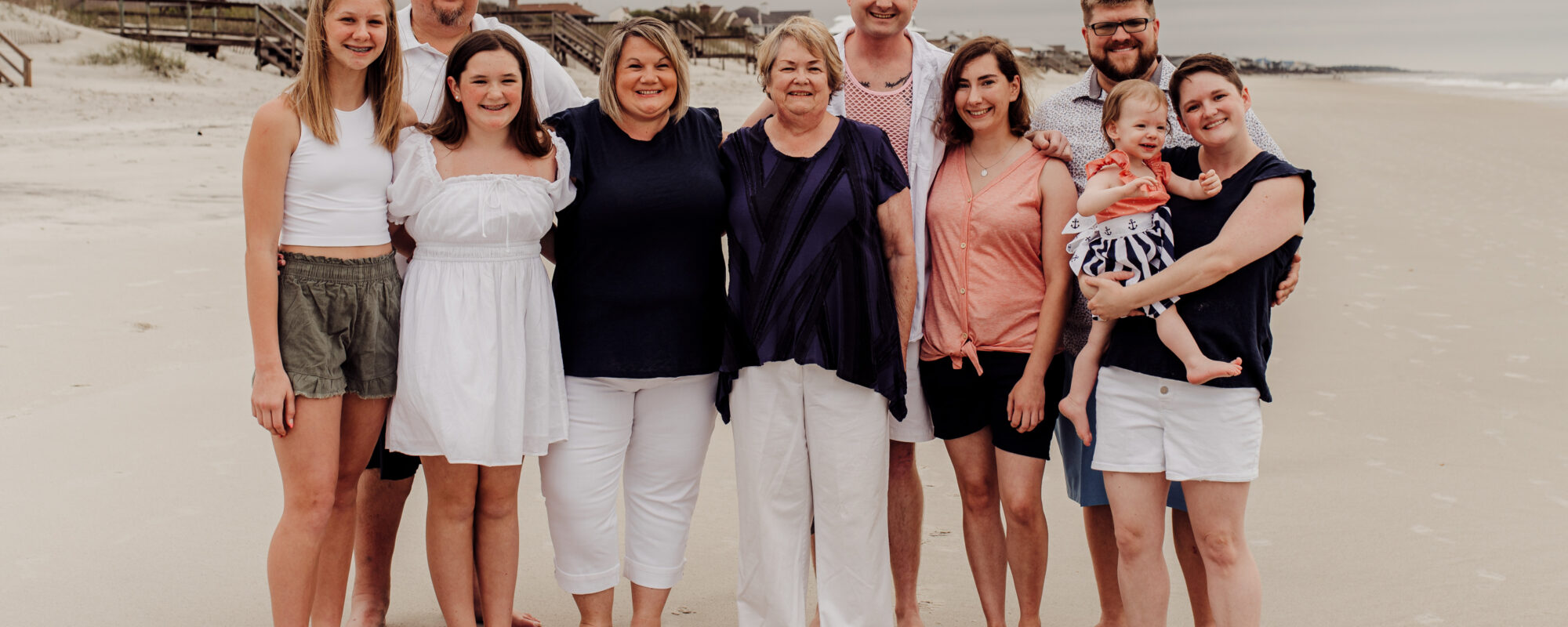 Penny family smiling at the beach