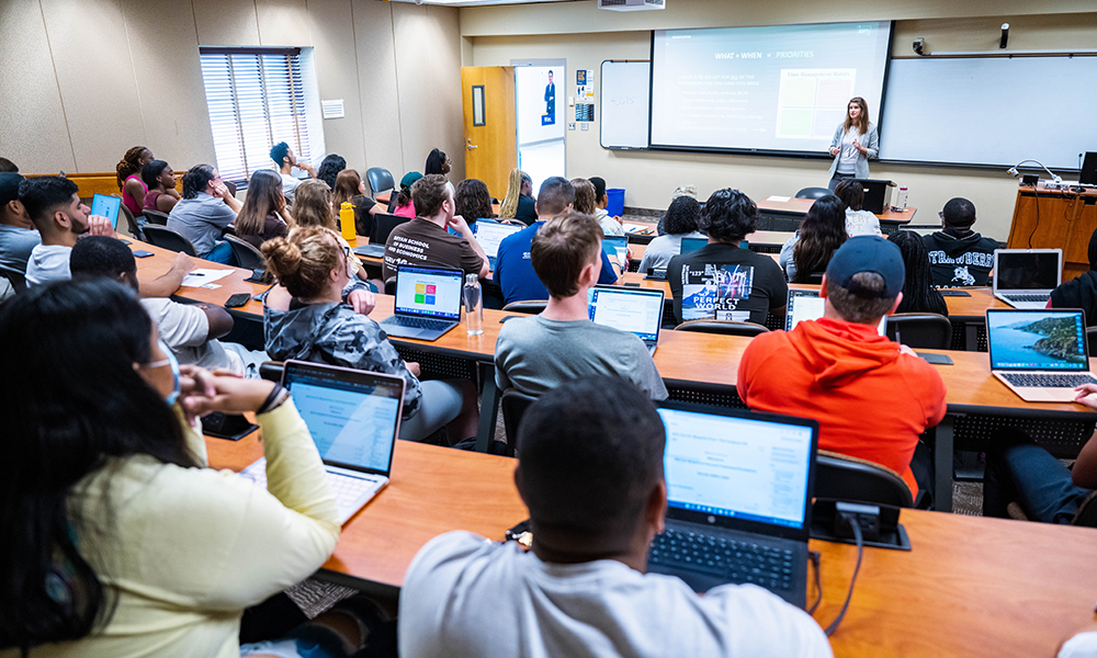 Lecture classroom full of students with instructor at the front